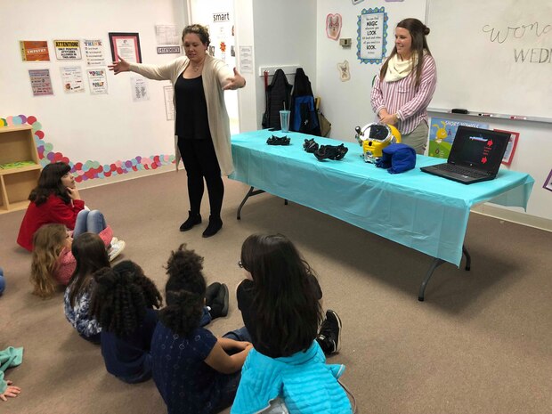 Naval Surface Warfare Center Panama City Division Science, Technology, Engineering, and Mathematics (STEM) Outreach Programs Manager Paige George (left) and Mechanical Engineer Allie Williams (right) describe diving and life support systems capabilities at a Girls Inc. STEM outreach event Jan. 30, 2019. U.S. Navy photo by Katherine Mapp