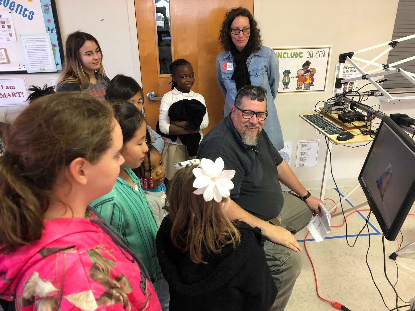Naval Surface Warfare Center Panama City Division Engineer Eric Pierce (right) demonstrates a three-dimensional face and head scanning technology to students during a Girls Inc. science, technology, engineering, and mathematics outreach event Jan. 30, 2019. U.S. Navy photo by Katherine Mapp
