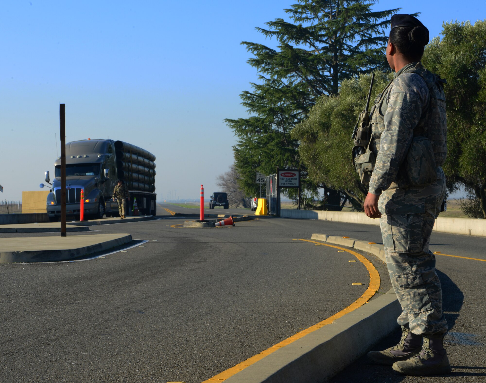 Airman 1st Class Taquita Clark, 9th Security Forces Squadron entry controller, stands guard at Wheatland Gate as vehicles make their approach