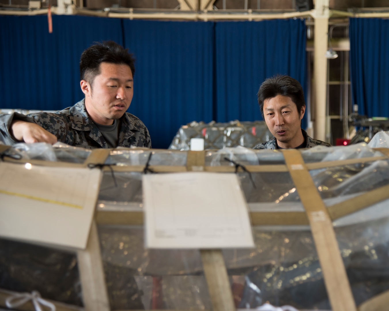 Two Japan Air Self-Defense Force airborne warning and control system supply transporters inspect supplies for exercise RED FLAG-Alaska 19-2 at Misawa Air Base, Japan, May 25, 2019. Both JASDF and U.S. Air Force logistic team members worked together in loading the supplies before attending the Red Flag exercise. (U.S. Air Force photo by Branden Yamada)
