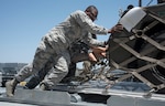 U.S. Air Force and Japan Air Self-Defense Force personnel push a supply pallet together into a loading truck at Misawa Air Base, Japan, May 25, 2019. The supply pallets included both U.S. Air Force and JASDF supplies for exercise RED FLAG-Alaska 19-2 exercise. (U.S. Air Force photo by Branden Yamada)