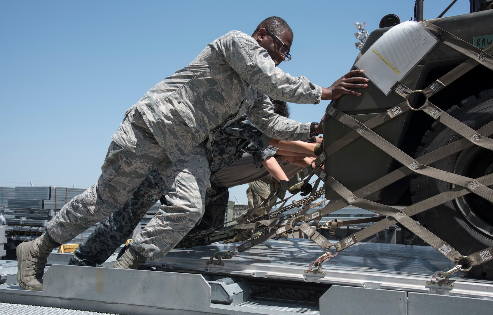 U.S. Air Force and Japan Air Self-Defense Force personnel push a supply pallet together into a loading truck at Misawa Air Base, Japan, May 25, 2019. The supply pallets included both U.S. Air Force and JASDF supplies for exercise RED FLAG-Alaska 19-2 exercise. (U.S. Air Force photo by Branden Yamada)