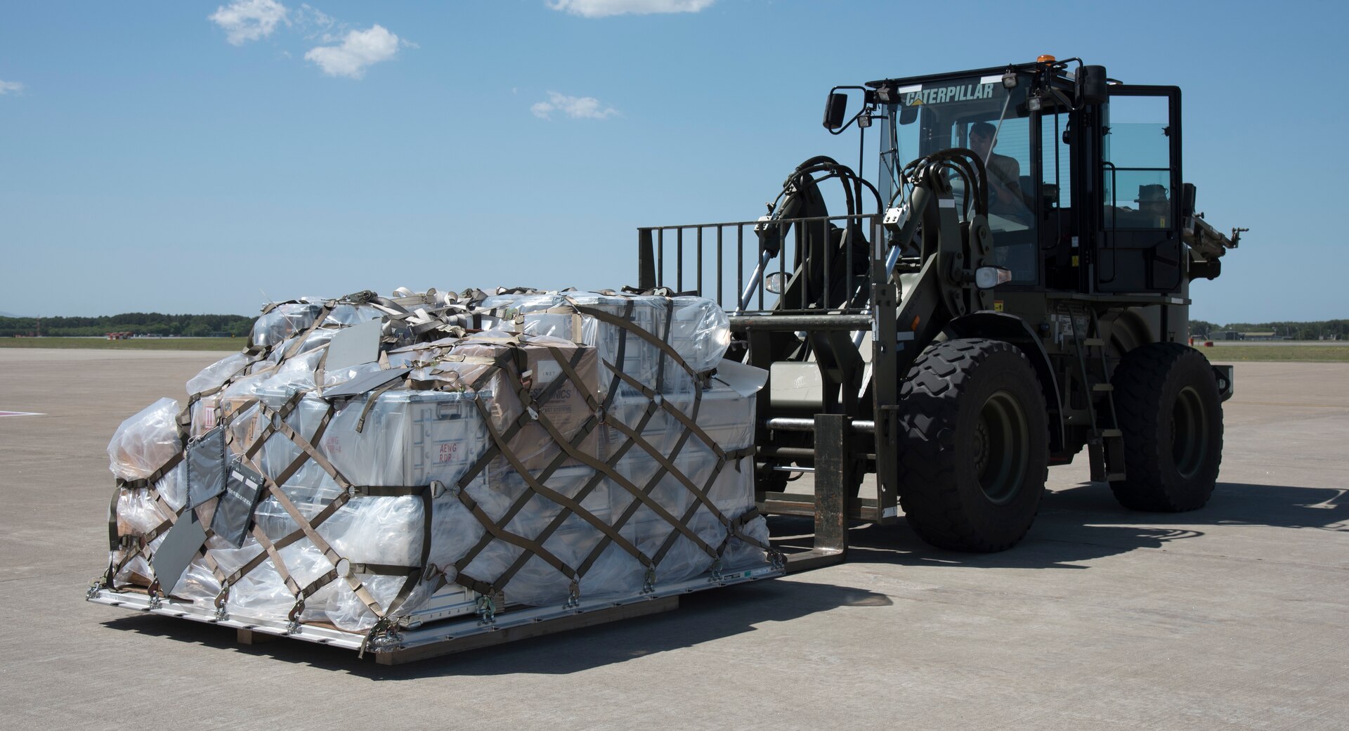 U.S. Air Force Staff Sgt. Tristan Caro, a 35th Logistics Readiness Squadron air transportation journeyman, moves a supply pallet at Misawa Air Base, Japan, May 25, 2019. Supplies are part of a U.S. and Japan Air Self-Defense Force bilateral cargo movement which supply military members with the necessary training equipment to participate in RED FLAG-Alaska 19-2. (U.S. Air Force photo by Branden Yamada)