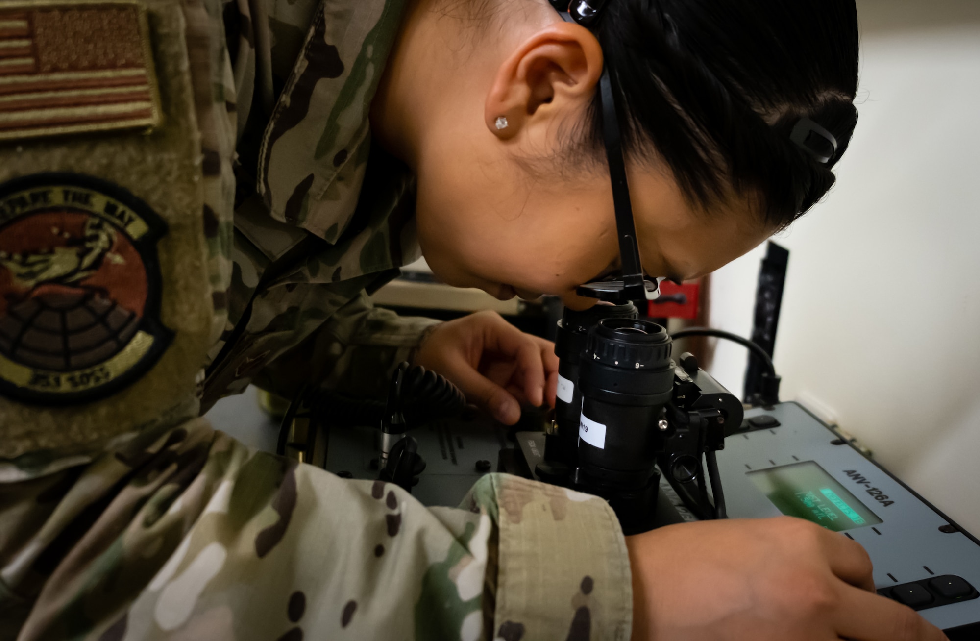 Airman 1st Class Samira Trimas, Aircrew Flight Equipment technician assigned to the 353rd Special Operations Support Squadron, inspects night vision goggles on Kadena Air Base, June 25, 2019.