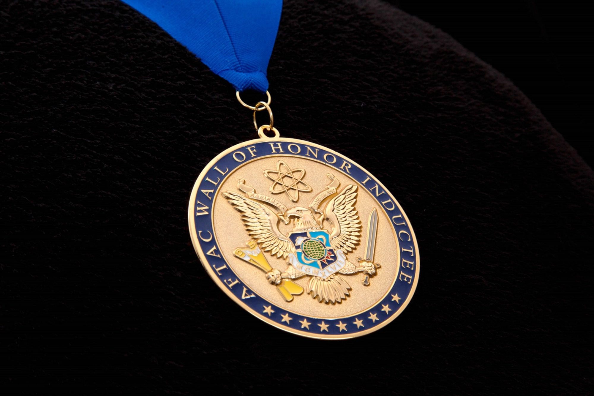 Pictured is the medallion presented to inductees on the Air Force Technical Applications Center's Wall of Honor.  The medallion, which was created by 1st Lt. Adam Satterfield and Master Sgt. Chad Taguba, former members of AFTAC, symbolizes the inductees' contributions to long range detection and nuclear treaty monitoring, AFTAC's primary mission.  The back of the medallion has a personalized inscription that reads, “Let this medallion signify its recipient is a member of an elite and noble group of Airmen who stand in silent vigil for the good of all humankind.”   (U.S. Air Force photo by Susan A. Romano)