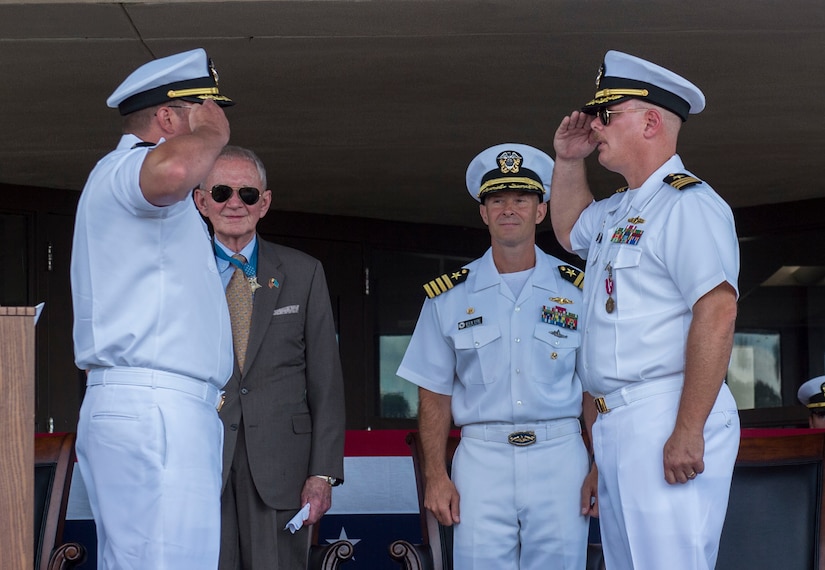 U.S. Navy Cmdr. Carl Brobst, outgoing commanding officer of Naval Consolidated (NAVCON) Brig Charleston, right, relinquishes command to U.S. Navy Cmdr. Jack Garcia, incoming commanding officer of NAVCON Brig Charleston, left, during a change of command ceremony June 28, 2019, Joint Base Charleston Naval Weapons Station, S.C. During the ceremony, Garcia relieved Brobst as commanding officer of NAVCON Brig Charleston. Garcia was previously the executive officer for NAVCON Brig Charleston. Brobst will be transferring to the Center for Surface Combat Systems Detachment, Mayport, Fla. NAVCON Brig Charleston’s mission is to ensure the security, good order and discipline, safety of adjudged and pretrial prisoners, and detain enemy combatants in accordance with guidance from the president through the secretary of defense. NAVCON Brig Charleston also aims to retrain and restore the maximum number of prisoners to honorable service and prepare members to be productive citizens outside of the military.
