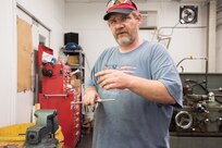 Patrick McGrail, a technician in the Towing Basin Operations (Mechanical) Branch of Naval Surface Warfare Center, Carderock Division, constructs a submarine part out of recycled metal material for the University of Waterloo’s one-person propeller submarine, Claire, on June 26.