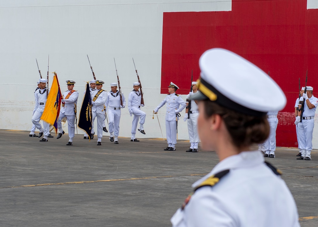 Ecuadorian service members parade their colors.