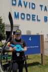Sarah Kemp, the pilot of the University of Warwick’s submarine, Godiva III, stands in front of the David Taylor Model Basin holding her team’s broken propeller on June 27 during the 2019 International Human-Powered Submarine Races at Naval Surface Warfare Center, Carderock Division in West Bethesda, Md.