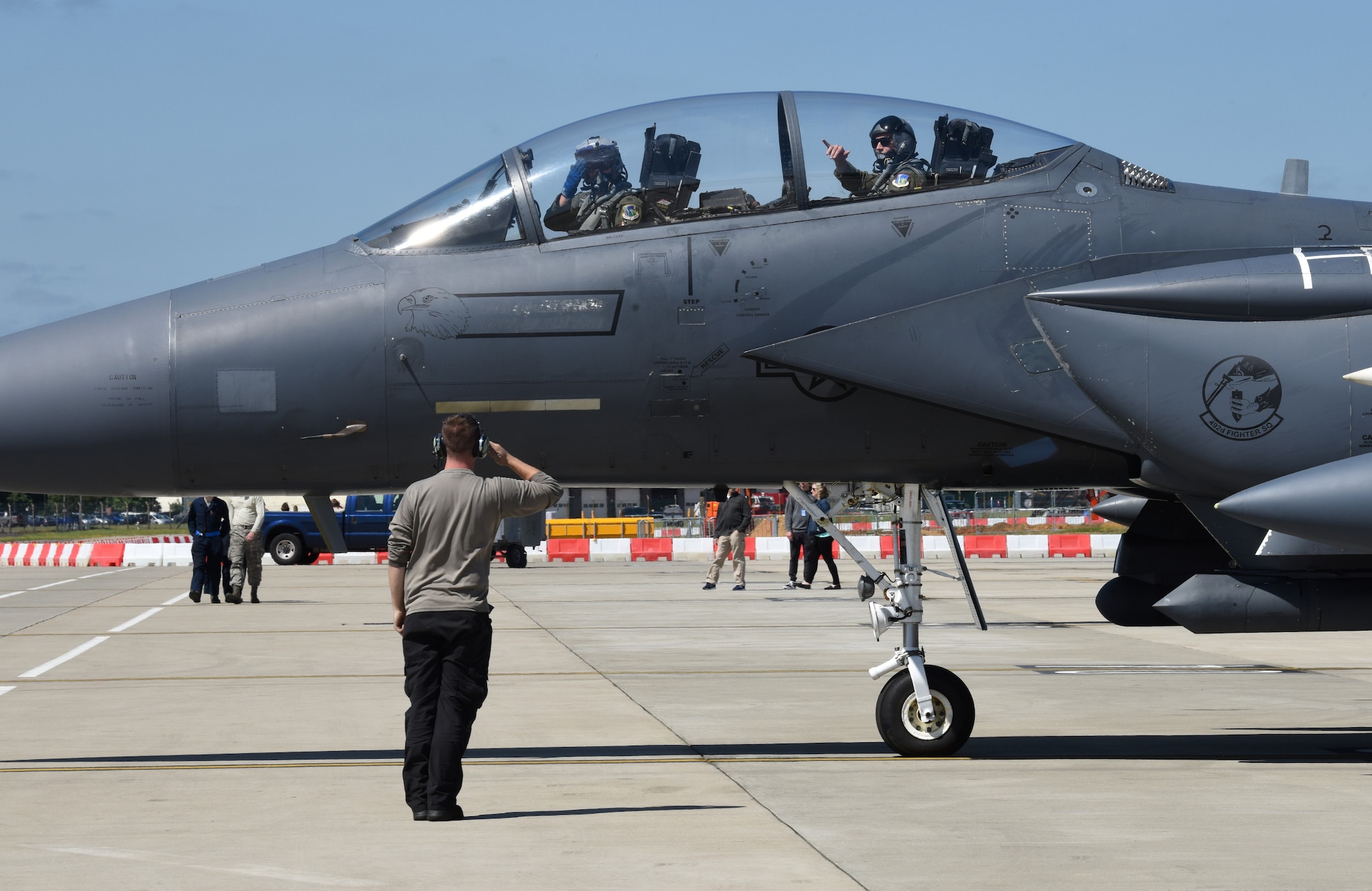 An aircraft maintainer, assigned to the 48th Maintenance Group, renders a salute to an F-15E Strike Eagle pilot before takeoff during Point Blank 19-2 at Royal Air Force Lakenheath, England, June 27, 2019. Approximately 52 aircraft from the U.S., France, and the U.K. participated in the exercise. (U.S. Air Force photo by Airman 1st Class Rhonda Smith)