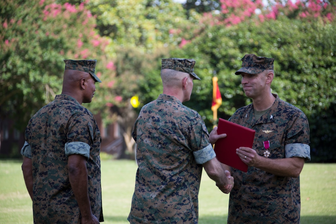 U.S. Marine Corps Col. Thomas H. Campbell III, right, the outgoing commanding officer of Headquarters and Service Battalion, U.S. Marine Corps Forces Command, is awarded the Legion of Merit during a change of command ceremony at Naval Support Activity Hampton Roads, Virginia, June 27, 2019. The change of command is a time-honored tradition where the responsibilities and authority of command are ceremoniously passed from one commander to the next. (U.S. Marine Corps photo by Sgt. Jessika Braden/ Released)