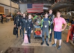 Students from Gulf Coast State College and Gulf Coast High School stand with one of the submarines at the International Human-Powered Submarine Races (ISR) on June 24, 2019.