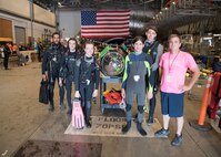 Students from Gulf Coast State College and Gulf Coast High School stand with one of the submarines at the International Human-Powered Submarine Races (ISR) on June 24, 2019.