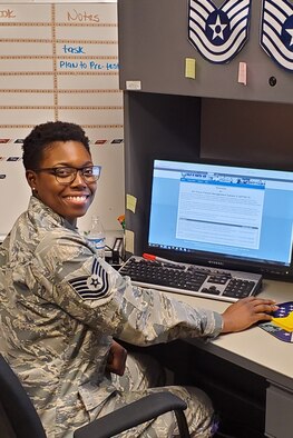 U.S. Air Force Tech. Sgt. Neosha Benson smiles while going about her daily duties as the 307th Force Support Squadron unit training manager at Barksdale Air Force Base, Louisiana (date).  Leadership from the 307th FSS nominated Benson for this year’s Bossier Chamber of Commerce Patriot Award. (courtesy photo)