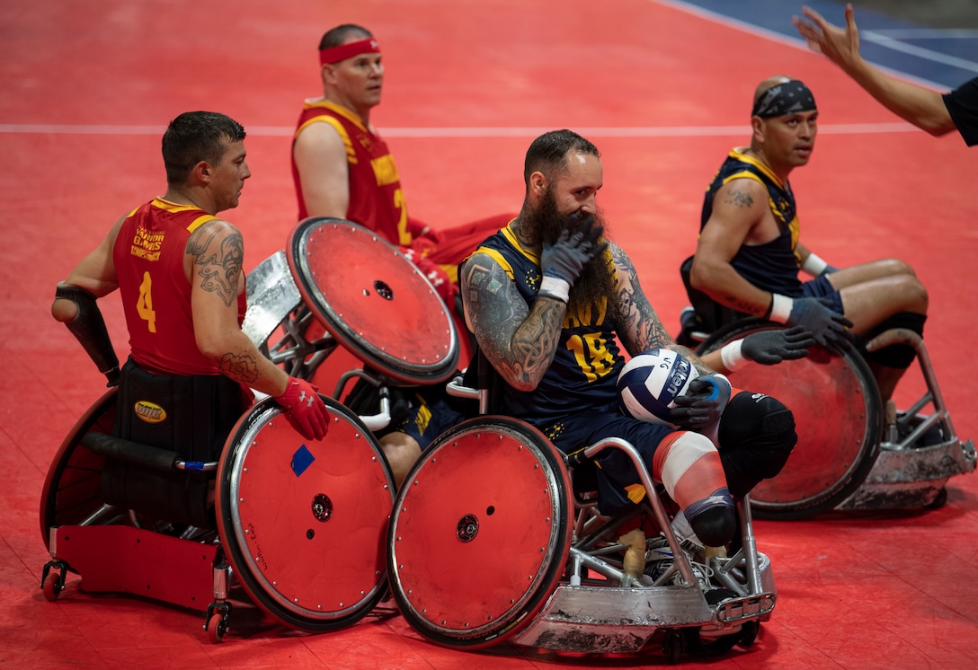 U.S. Marine Corps and Navy wheelchair rugby teams get caught in a collision at the DoD Warrior Games in Tampa, Florida, June 27, 2019. The DoD Warrior Games showcase the resilient spirit of today’s wounded, ill or injured service members from all branches of the military and provide a venue for recovering service members and veterans to demonstrate triumph over significant physical or invisible wounds and injuries.