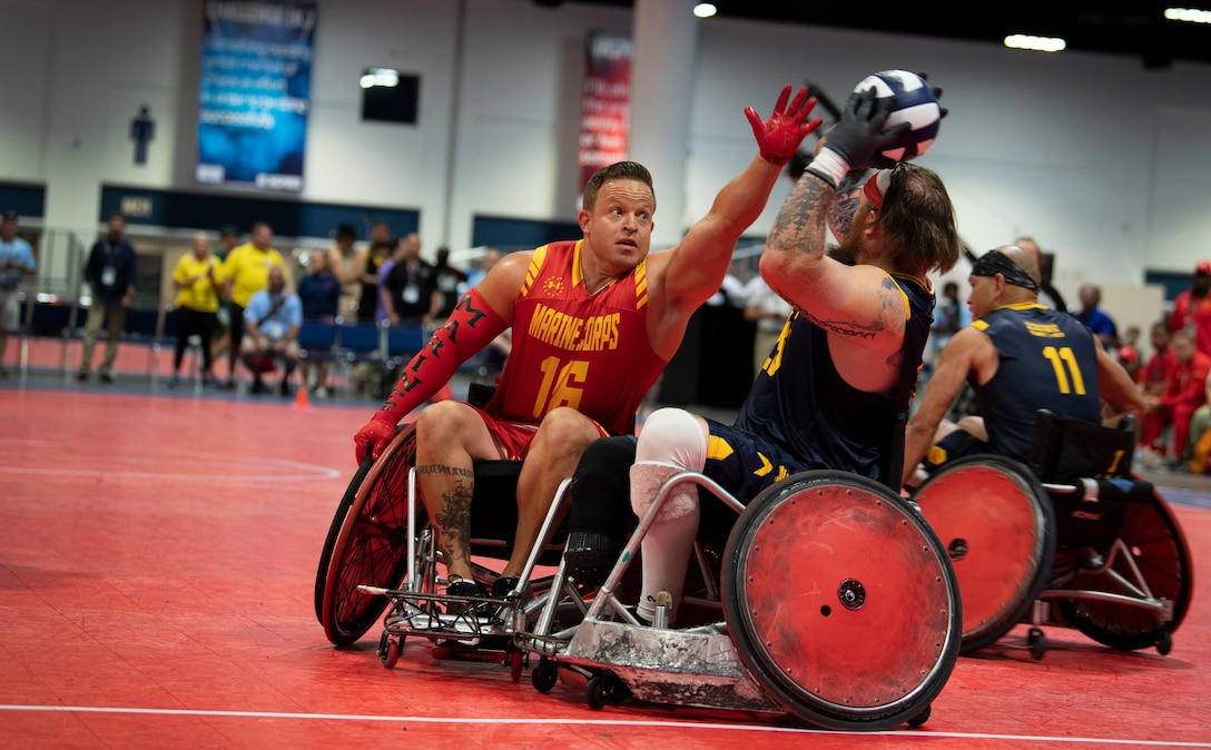 U.S. Marine Corps Gunnery Sgt. Steven McKay defends against team Navy at the DoD Warrior Games Wheelchair Rugby competition in Tampa, Florida, June 27, 2019. The DoD Warrior Games is an adaptive sports competition for wounded, ill and injured service members and veterans. The 2019 Warrior Games consist of 13 Paralympic-style sports, and more than 300 athletes representing the U.S. Marine Corps, Army, Navy, Air Force, Special Operations Command, and five international teams.