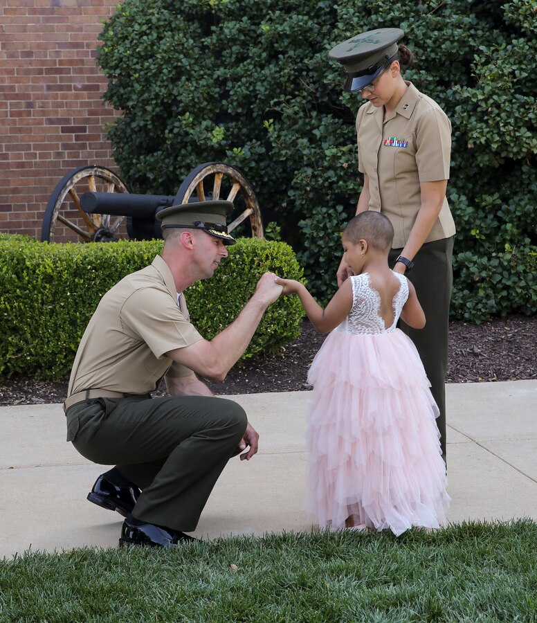 Colonel Donald J. Tomich, Marine Barracks Washington commanding officer, speaks with Analia Naylin Pages after parade practice at Marine Barracks Washington, D.C., June 28, 2019. Analia Naylin Pages, the daughter of Master Sgt. Edward Pages III and retired Gunnery Sgt. Ana Liz Perez has B-Cell Acute Lymphoblastic Leukemia and served as our guest of honor for the parade practice.