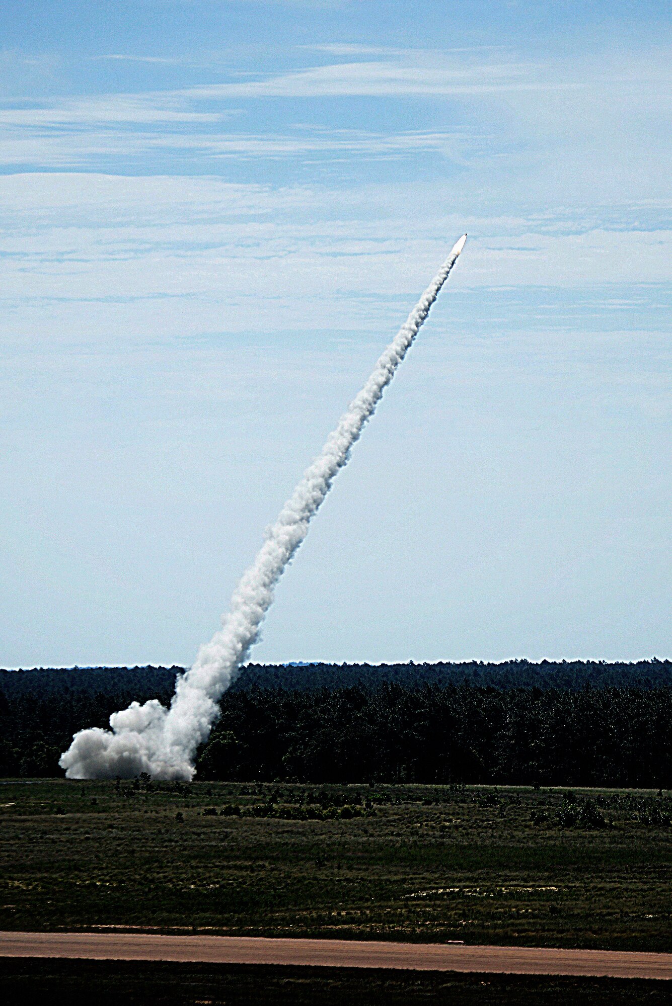 A High Mobility Artillery Rocket System launches a rocket at Ft. Bragg, North Carolina, June 25, 2019. The U.S. Army and Air Force have been conducting exercises that deliver HIMARS vehicles within a 186-mile range of the target, to fire and then rapidly extract, utilizing a C-17 Globemaster III.