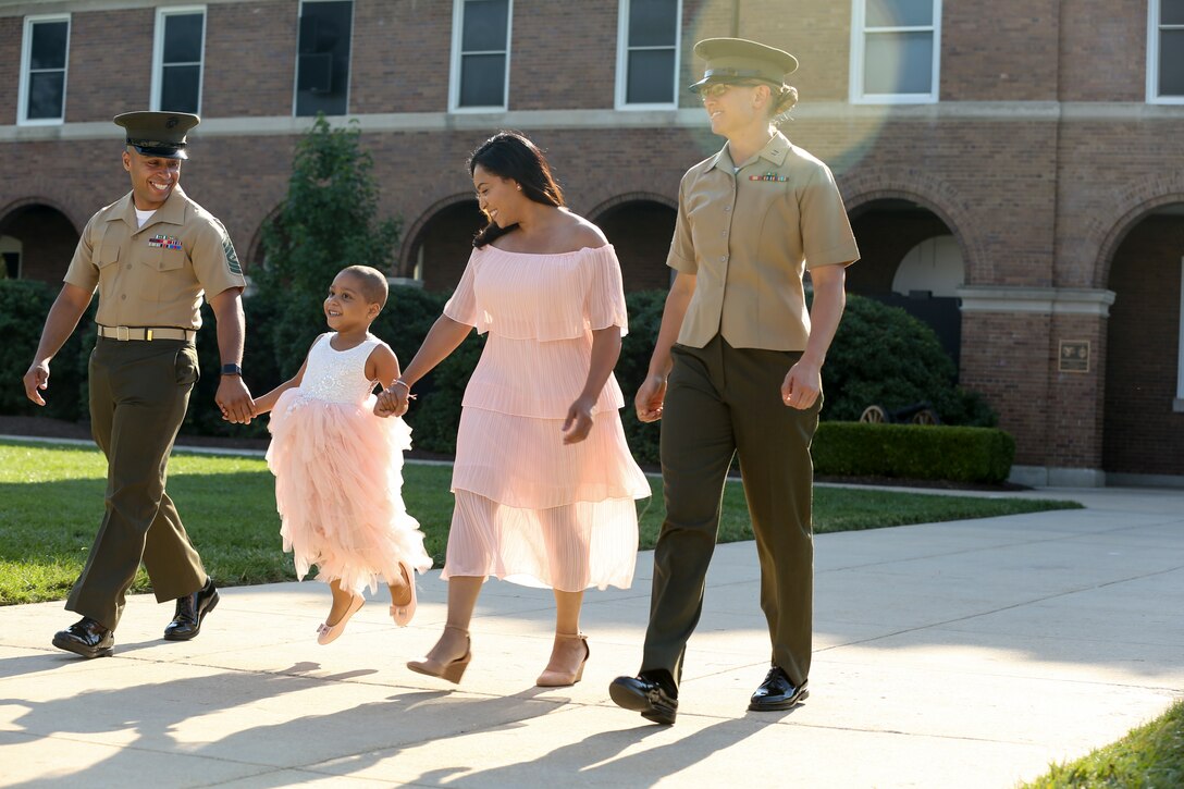 Analia Naylin Pages, along with her parents and Captain Caroline Locksmith, walk down center walk during parade practice at Marine Barracks Washington, D.C., June 28, 2019. Analia Naylin Pages, the daughter of Master Sgt. Edward Pages III and retired Gunnery Sgt. Ana Liz Perez has B-Cell Acute Lymphoblastic Leukemia and served as our guest of honor for the parade practice.