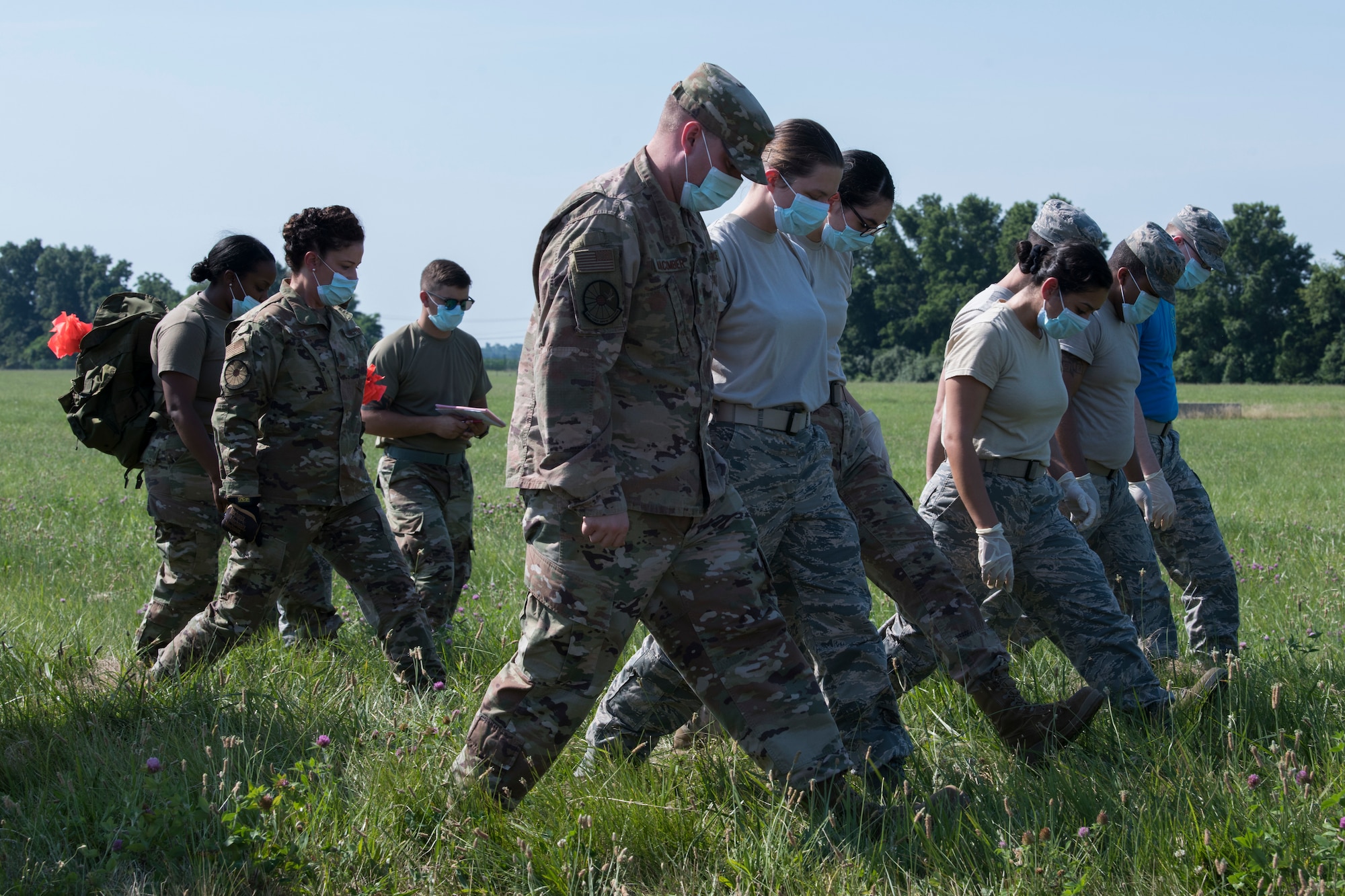Airmen from the 436th Force Support Squadron conduct a search during a search-and-recovery exercise June 28, 2019, at Dover Air Force Base, Del. The team of 11 was tasked with surveying a field as part of an aircraft mishap simulation. (U.S. Air Force photo by Senior Airman Christopher Quail)