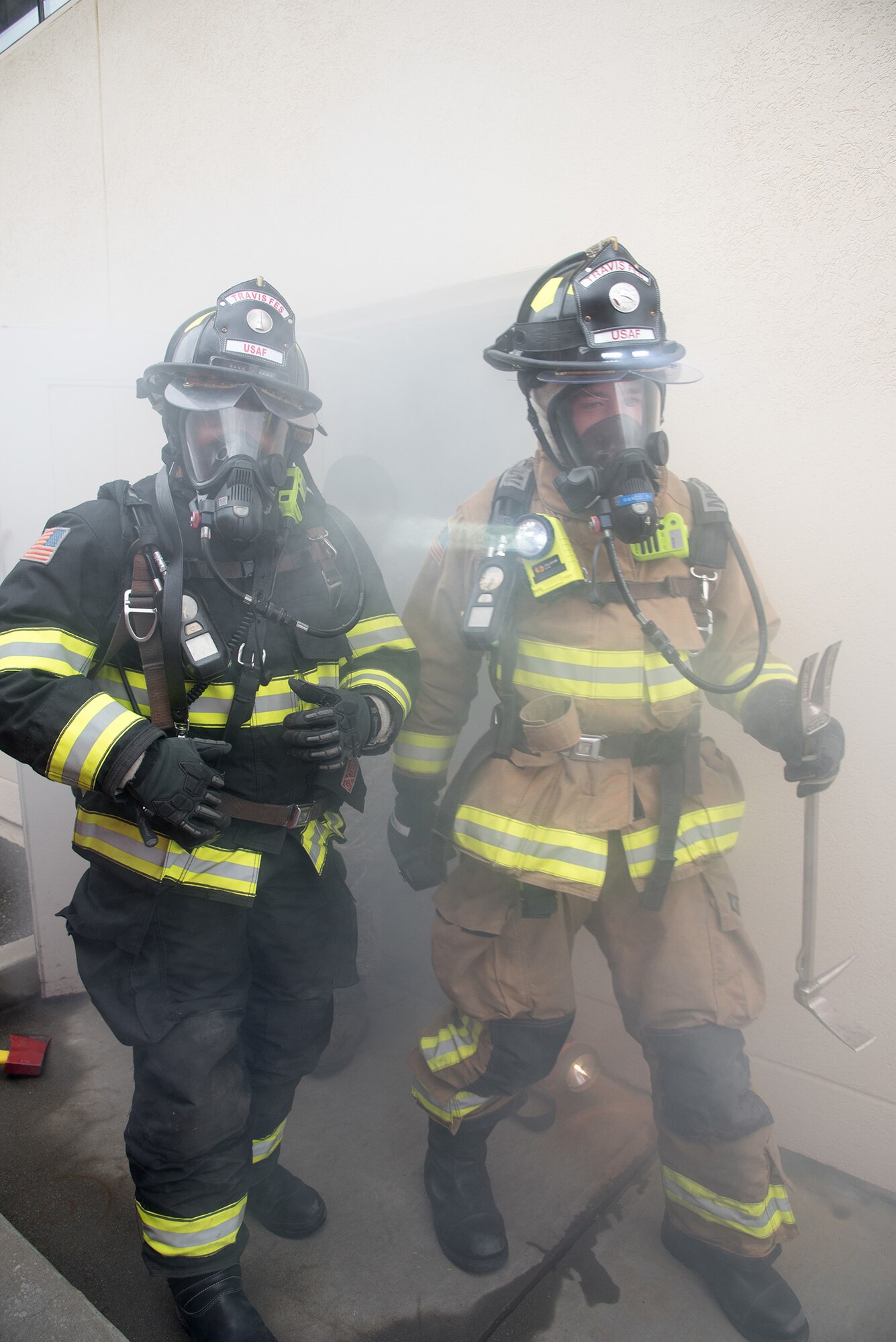 on't let this happen at your home! Senior Airman Romney Allen and Airman 1st Class Matthew Randolph, 60th Civil Engineer Squadron firefighters, walk out of a smoke-filled building after performing search and rescue training.