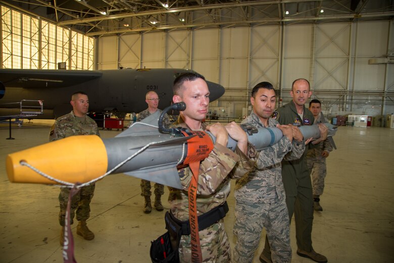 Brig. Gen. E. John Teichert, 412th Test Wing Commander, and Chief Master Sgt. Ian Eishen, 412th Test Wing Command Chief, prepare to load a missile at Edwards Air Force Base, California, June 18. (U.S. Air Force photo by Christopher Okula)