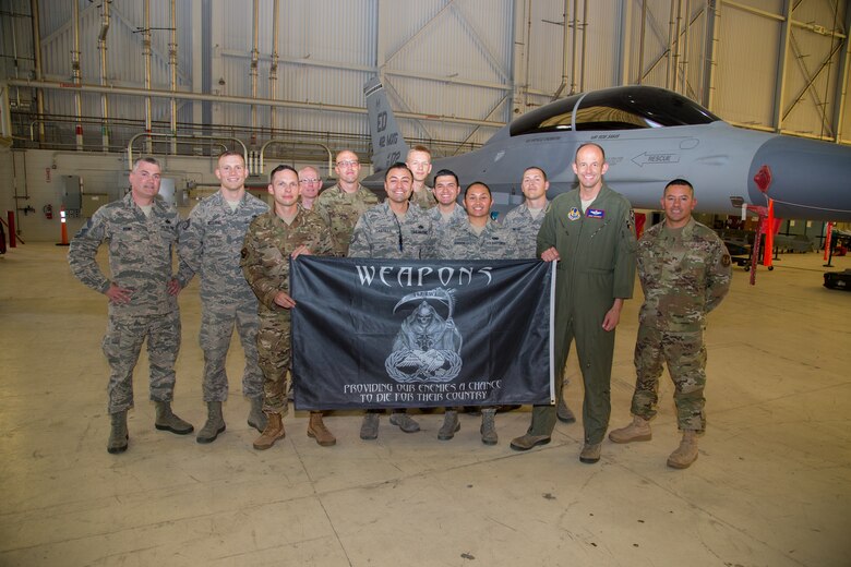 Brig. Gen. E. John Teichert, 412th Test Wing Commander, and Chief Master Sgt. Ian Eishen, 412th Test Wing Command Chief, pose for a photo with the 412th Maintenance Group Weapons Team at Edwards Air Force Base, California, June 18. (U.S. Air Force photo by Christopher Okula)