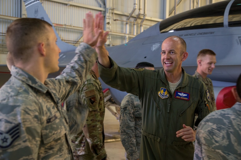 Brig. Gen. E. John Teichert, 412th Test Wing Commander, gives a high-five to a Team Edwards member at Edwards Air Force Base, California, June 18. Teichert and 412th Test Wing Command Chief, Chief Master Sgt. Ian Eishen visited the 412th Maintenance Group Weapons Team to learn about their jobs. (U.S. Air Force photo by Christopher Okula)
