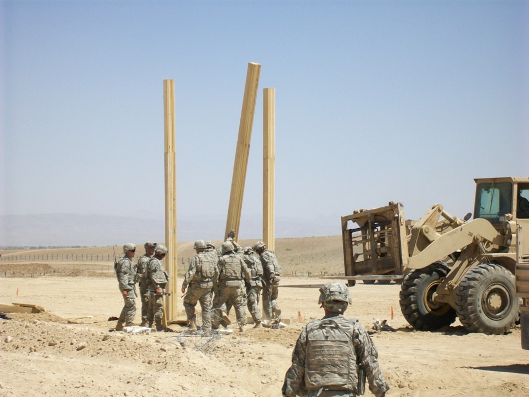 Army personnel building an observation platform in the Middle East using a materials list provided by the Joint Construction Management System (JCMS) database. The JCMS provides lists of materials, construction cost, labor estimates and standards. Army Facilities Component Systems ensure the JCMS remains up to date and can support theater combatant commands and service component commands with construction planning.