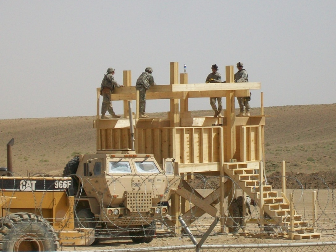Army personnel building an observation platform in the Middle East using a materials list provided by the Joint Construction Management System (JCMS) database. The JCMS provides lists of materials, construction cost, labor estimates and standards. Army Facilities Component Systems ensure the JCMS remains up to date and can support theater combatant commands and service component commands with construction planning.