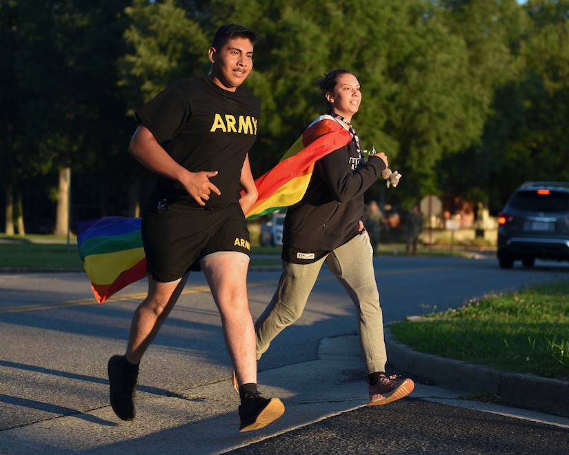 Event participants run wearing rainbow attire during a Pride Observance Month 5K run at Joint Base Langley-Eustis, Virginia, June 21, 2019.