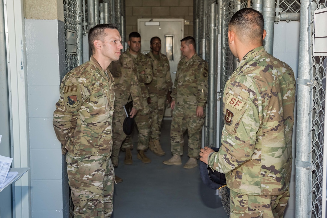 Chief Master Sgt. Ian Eishen, 412th Test Wing Command Chief, receives a briefing during his visit to the working dog kennels at Edwards Air Force Base, California, June 27. (U.S. Air Force photo by Matthew Williams)