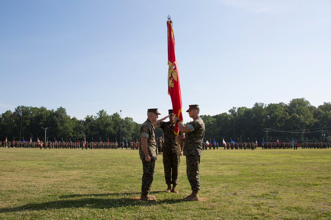 U.S. Marine Corps Col. Brian W. Neil, right, the outgoing commanding officer of Marine Corps Security Force Regiment, U.S. Marine Corps Forces Command, passes the colors to Col. Corey M. Collier, the incoming regiment commanding officer, during a change of command ceremony at Naval Weapons Station Yorktown, Yorktown, Virginia, June 28, 2019. The change of command is a time-honored tradition where the responsibilities and authority of command are ceremoniously passed from one commander to the next. (U.S. Marine Corps photo by Sgt. Jessika Braden/ Released)