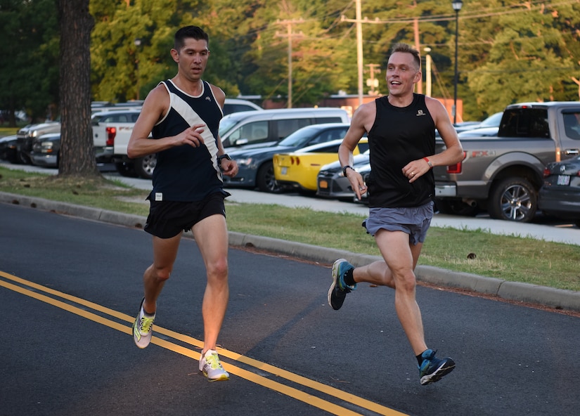 Two participants in the Army Ten-Miler try-outs run a 6.5 mile course at Joint Base Langley-Eustis, Virginia, June 28, 2019. The Army Ten-Miler will be held in Washington D.C. Oct. 13. (U.S. Air Force photo by Senior Airman Delaney Gonzales)