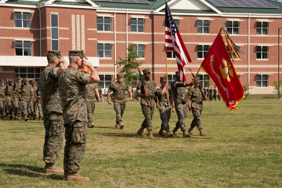 U.S. Marine Corps Col. Corey M. Collier, the incoming commanding officer of Marine Corps Security Force Regiment, U.S. Marine Corps Forces Command, and Sgt. Maj. Christopher Adams, the regiment’s command sergeant major, salute the Nation’s colors during a pass in review as part of a change of command ceremony at Naval Weapons Station Yorktown, Yorktown, Virginia, June 28, 2019. The change of command is a time-honored tradition where the responsibilities and authority of command are ceremoniously passed from one commander to the next. (U.S. Marine Corps photo by Sgt. Jessika Braden/ Released)