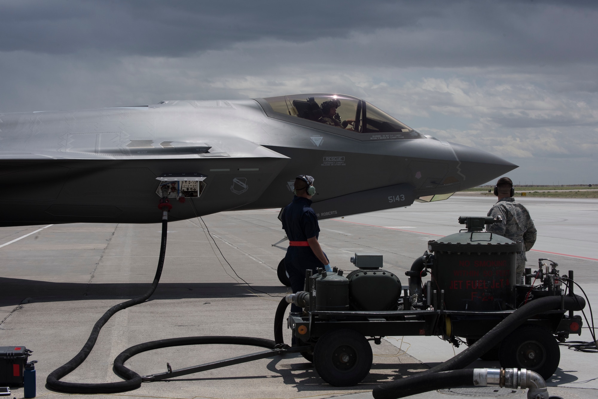 Senior Airman Michael Rogers, 388th Aircraft Maintenance Squadron avionics techinician, and Senior Airman Christian Cook, 366th Logistics Readiness Squadron fuels operator, performs a hotpits refueling with a hose cart from the 1970s on an F-35 Lightning II from Hill Air Force Base, Utah, June 20, 2019, at Mountain Home Air Force Base, Idaho. A hot-pit allows aircraft to refuel without turning the engine off and quickly return to the air. The traditional refueling process can take more than an hour before the aircraft can take off, while a hot-pit takes 13 minutes. (U.S. Air Force photo by Airman First Class Andrew Kobialka)