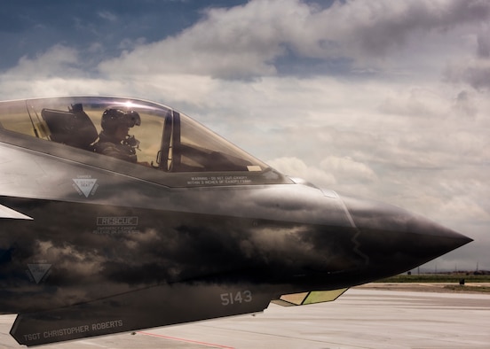 An F-35 Lightning II pilot from Hill Air Force Base, Utah, waits to taxi onto the runway June 20, 2019, at Mountain Home Air Force Base, Idaho. This double exposure photo was captured in camera by combining two perspectives, a photo of the F-35 and photo of the sky, to create a singular image. (U.S. Air Force photo by Airman First Class Andrew Kobialka)