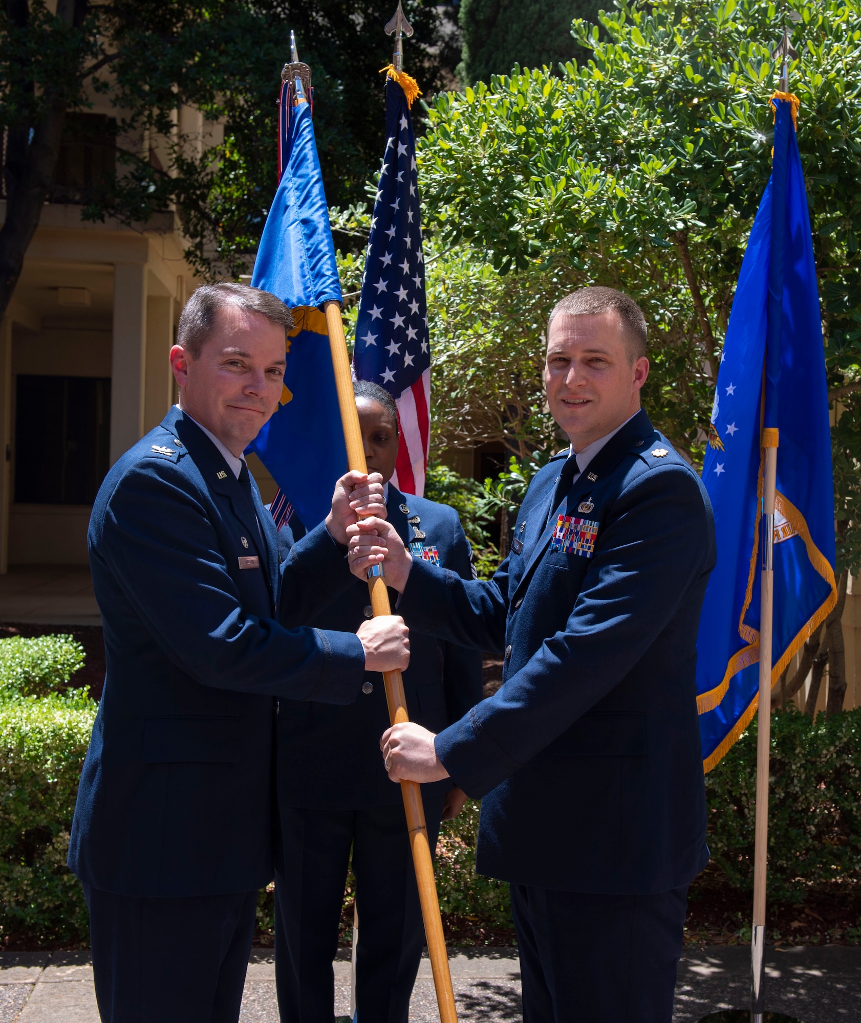 U.S. Air Force Maj. Andrew Wilkins, right, assumes command of the 60th Comptroller Squadron from Col. Jeff Nelson, 60th Air Mobility Wing commander, June 28, 2019, at Travis Air Force Base, California. During the ceremony, Mitchell passed the reign of command to Maj. Andrew Wilkins. (U.S. Air Force photo by Airman 1st Class Jonathon Carnell)
