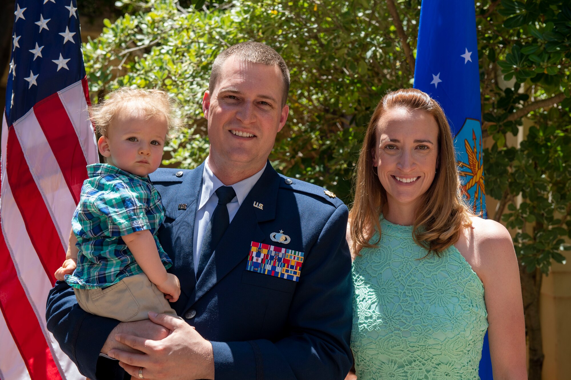 U.S. Air Force Maj. Andrew Wilkins, poses for a photo with his son, Ethan, and his wife, Rhiannon after a change of command ceremony where the Major assumed command of the 60th Comptroller Squadron June 28, 2019, at Travis Air Force Base, California.  During the ceremony, Mitchell passed the reign of command to Maj. Andrew Wilkins. (U.S. Air Force photo by Airman 1st Class Jonathon Carnell)