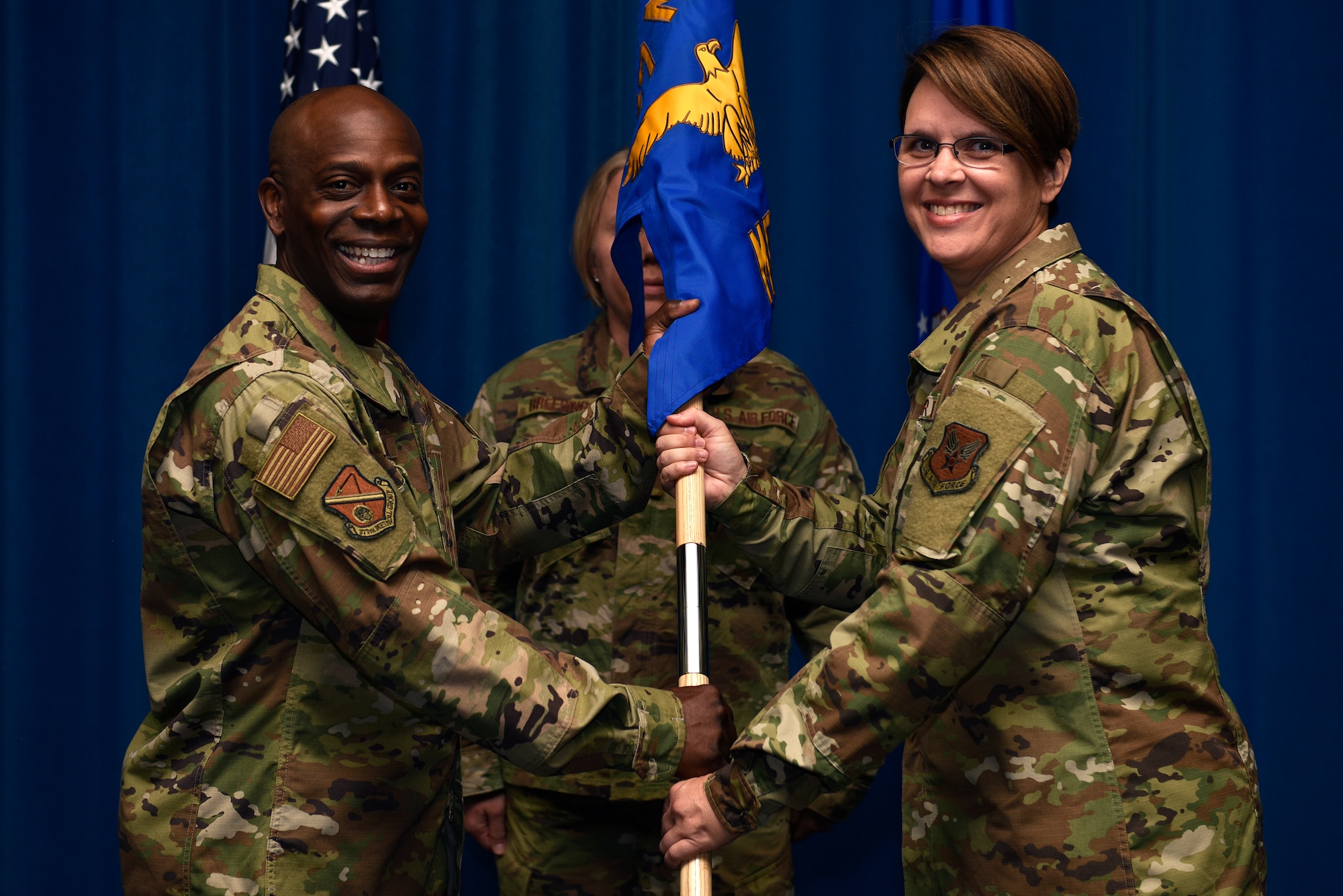 U.S. Air Force Lt. Col. Kelly Detering (right), accepts the guidon and command of the 377th Medical Support Squadron from Col. Gregory Coleman, 377th Medical Group commander, in an assumption of command ceremony at Kirtland Air Force Base, N.M., July 1, 2019. Detering comes to Kirtland from the Surgeon General’s office where she served as the Air Force Medical Service and Defense Health Agency transition officer. (U.S. Air Force photo by Airman 1st Class Austin J. Prisbrey)