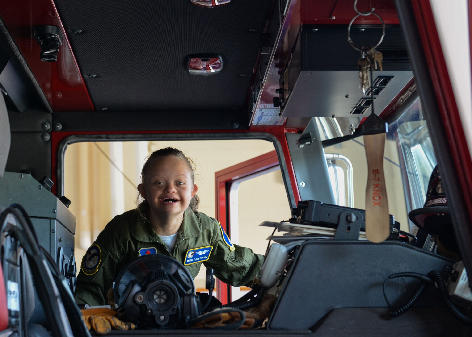 Aubrey Armstrong, Pilot for a Day, smiles as she enters a fire truck at the Columbus Air Force Base Fire Department June 25, 2019, on Columbus AFB, Miss. Aubrey met the firefighters from the 14th CES and sprayed the hose from the firetruck. (U.S. Air Force photo by Airman Davis Donaldson)