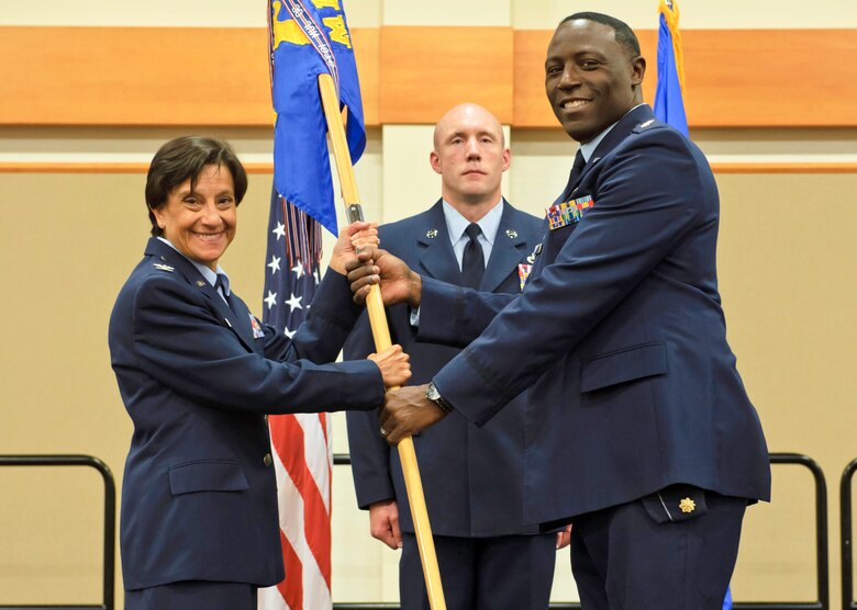 Maj. Antoine Bills, right, accepts command of the 341st Logistics Readiness Squadron from Col. Lisa Martinez, 341st Mission Support Group commander, during a change of command ceremony July 1, 2019, at Malmstrom Air Force Base, Montana.