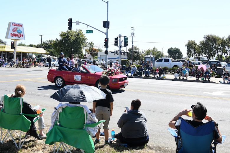 Chief Master Sgt. Daryl Hogan Jr., 30th Space Wing command chief, and his family participate in the 2019 Lompoc Flower Festival Parade June 29, 2019, in Lompoc, Calif.