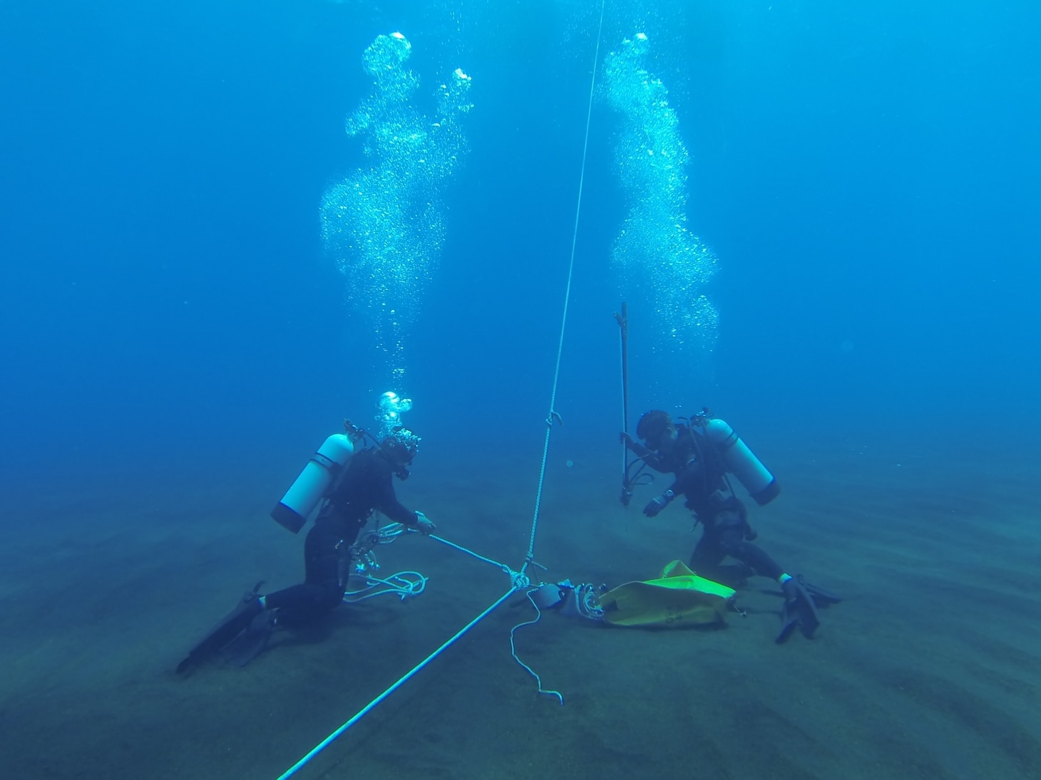 IWO TO, Japan (June 18, 2019) Explosive ordnance disposal technicians assigned to the Japan Maritime Self-Defense Force (JMSDF) and the U.S. Navy participate in a live bottom mine contact charge demonstration during IWOTO 2019. IWOTO 2019 is one of the largest live mine countermeasures exercises conducted in the entire world, providing personnel with the opportunity to conduct contact charges and FMRs against real mines without sensor packages.