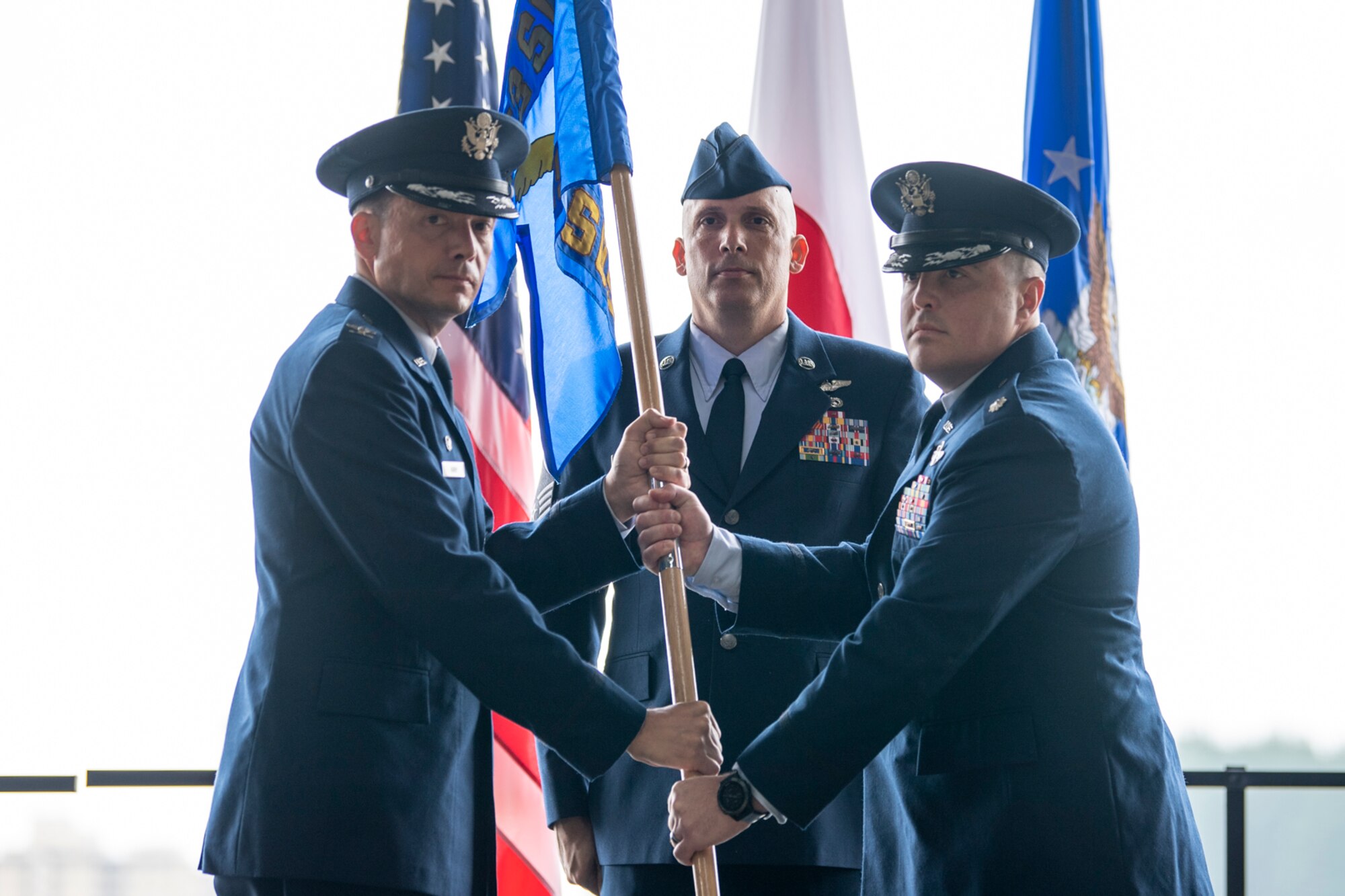 Lt. Col. Jason Hock (right) accepts the guidon of the 21st Special Operations Squadron from Col. Jason Kirby, 353rd Special Operations Group commander, during an assumption of command ceremony at Yokota Air Base, Japan, July 1, 2019.