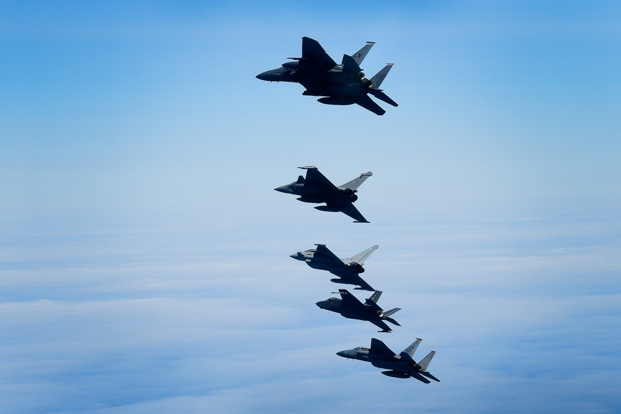 U.S. Air Force fourth and fifth-generation aircraft fly in an echelon formation with a Royal Air Force Typhoon and a French Rafale in support of exercise Pointblank 19-2, over the North Sea, June 27, 2019. The objective of the exercise is to prepare coalition warfighters for a highly contested fight against near-peer adversaries by providing a multi-dimensional battle-space to conduct advanced training in support of US, UK and French national interests. (U.S. Air Force photo/ Tech. Sgt. Matthew Plew)