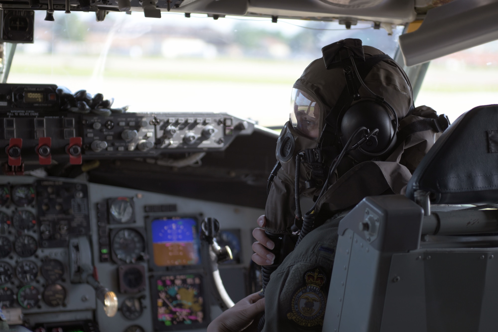 U.S. Air Force 1st Lt. Kelly Hightaian, 351st Air Refueling Squardron co-pilot, dons her gas mask before supporting Exercise Point Blank at RAF Mildenhall, England, June 27, 2019. Military training and exercises with allies and partners is vital to our operational readiness and capability to respond anytime, anywhere. (U.S. Air Force photo by Senior Airman Benjamin Cooper)