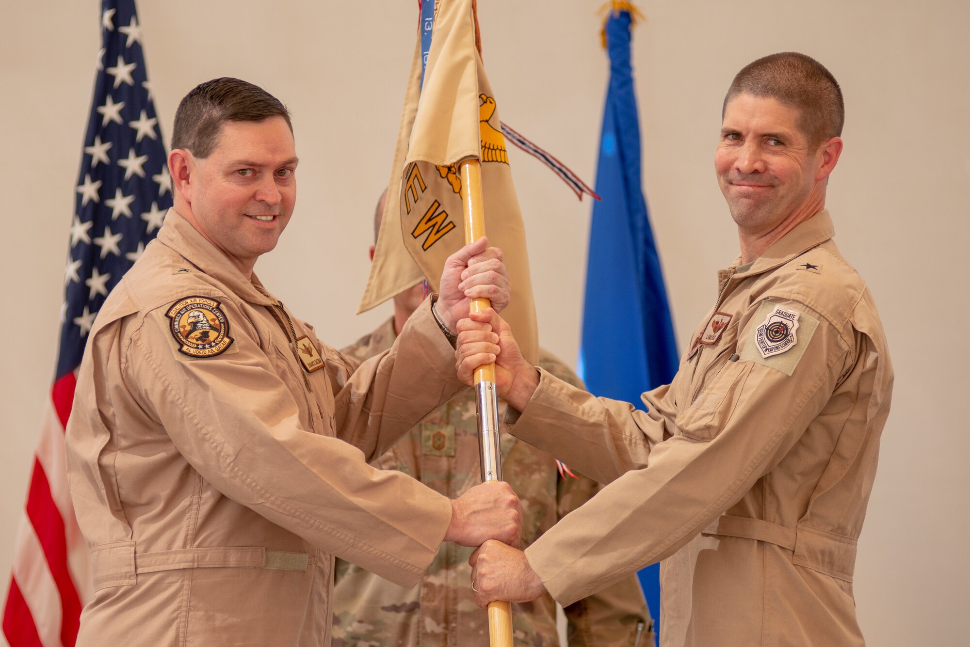 Brig. Gen. Lance Pilch, right, assumes command of the 380th Air Expeditionary Wing during the change of command ceremony July 1, 2019, at Al Dhafra Air Base, United Arab Emirates.