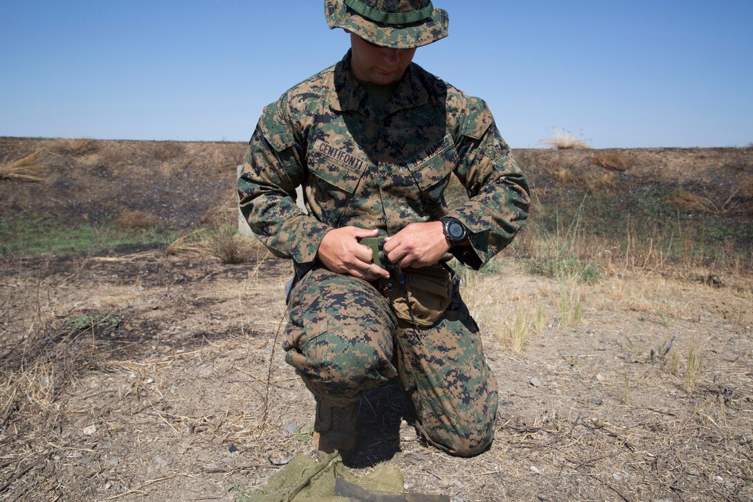 A U.S. Marines with the Special Purpose Marine Air-Ground Task Force-Crisis Response-Africa 19.2, Marine Forces Europe and Africa, wires a blasting cap to a detonator during an advanced-manufacturing charge range at Naval Air Station Sigonella, Italy, June 25, 2019. Explosive ordnance disposal technicians with SPMAGTF-CR-AF 19.2 conducted the range using shaped charges and colliding shockwave charge platforms designed and developed on a 3-D printer. The training exercise advanced the technician’s expertise by developing and testing specialized charges. SPMAGTF-CR-AF is deployed to conduct crisis-response and theater-security operations in Africa and promote regional stability by conducting military-to-military training exercises throughout Europe and Africa. (U.S. Marine Corps photo by Staff Sgt. Mark E. Morrow Jr.)
