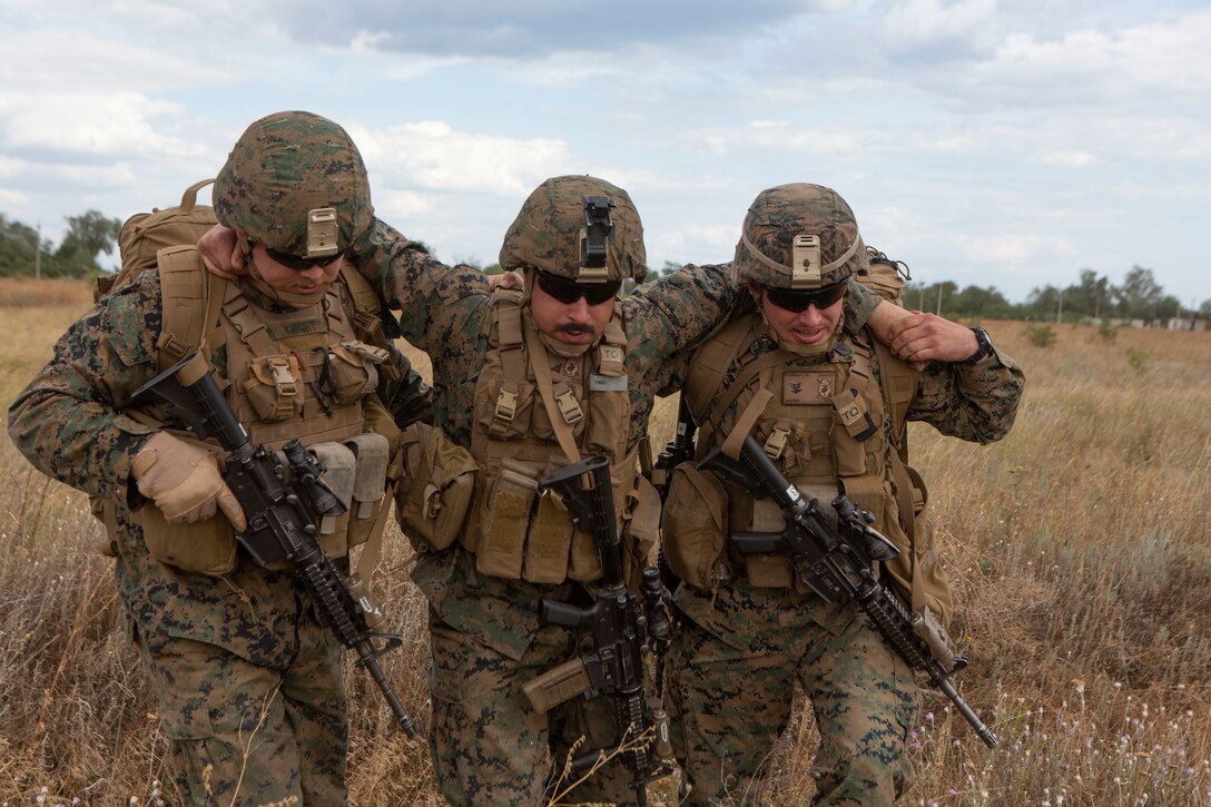 U.S. Navy Sailors with Marine Rotational Force-Europe 19.2, Marine Forces Europe and Africa, perform an assisted carry on a simulated casualty during Sea Breeze 19 in Chabanka, Ukraine, June 29, 2019.